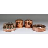 Four Victorian copper jelly moulds, the first of circular buttressed form, the plain rim with No.