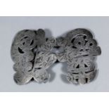 A Chinese silvery metal buckle cast in the form of character marks and engraved with bamboo shoots