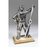 An early 20th Century desk lighter modelled as a nickel plated spelter figure of a standing Airman