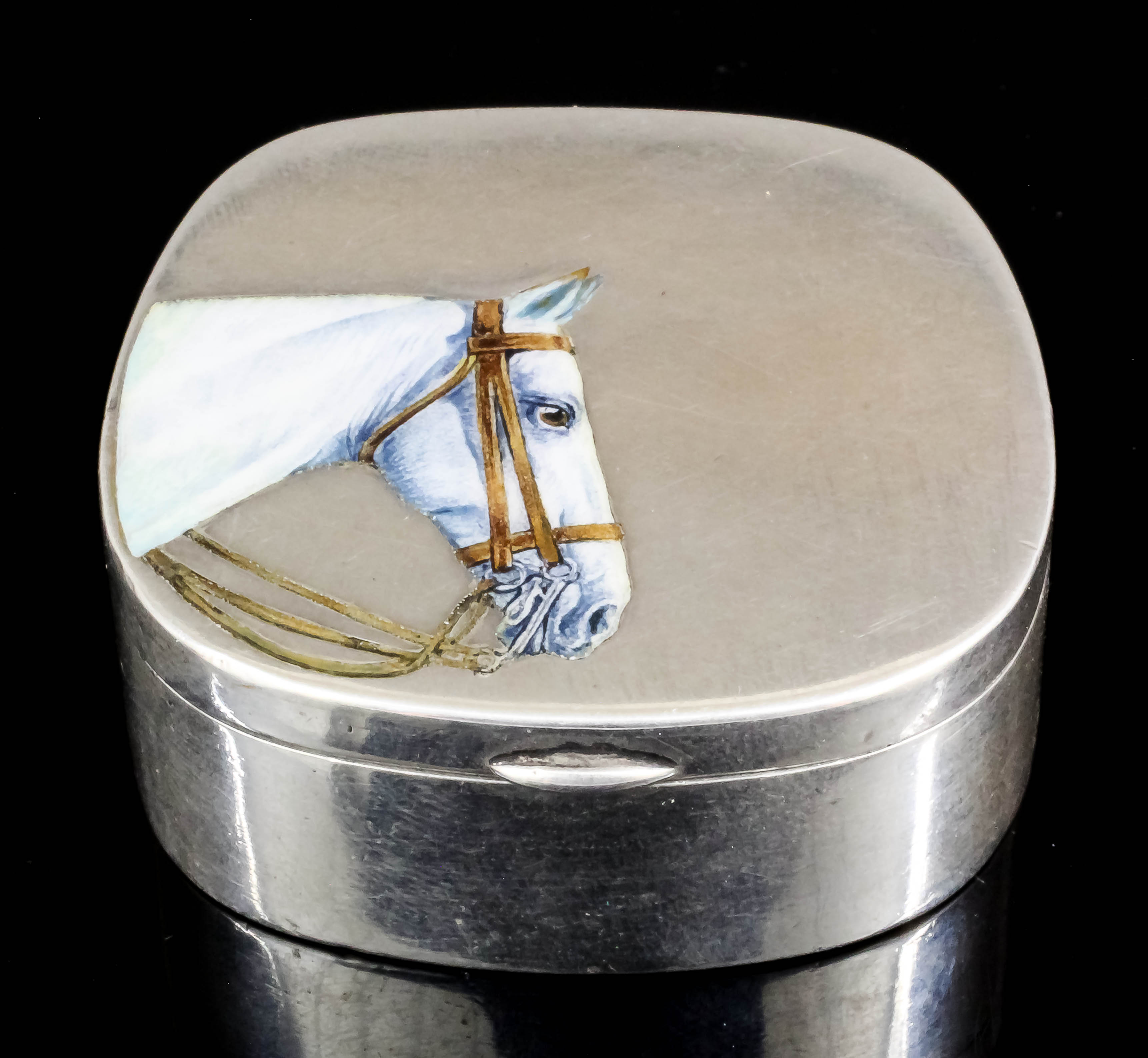 An early 20th Century silvery metal patch box the cover enamelled with the head of a grey Hunter,