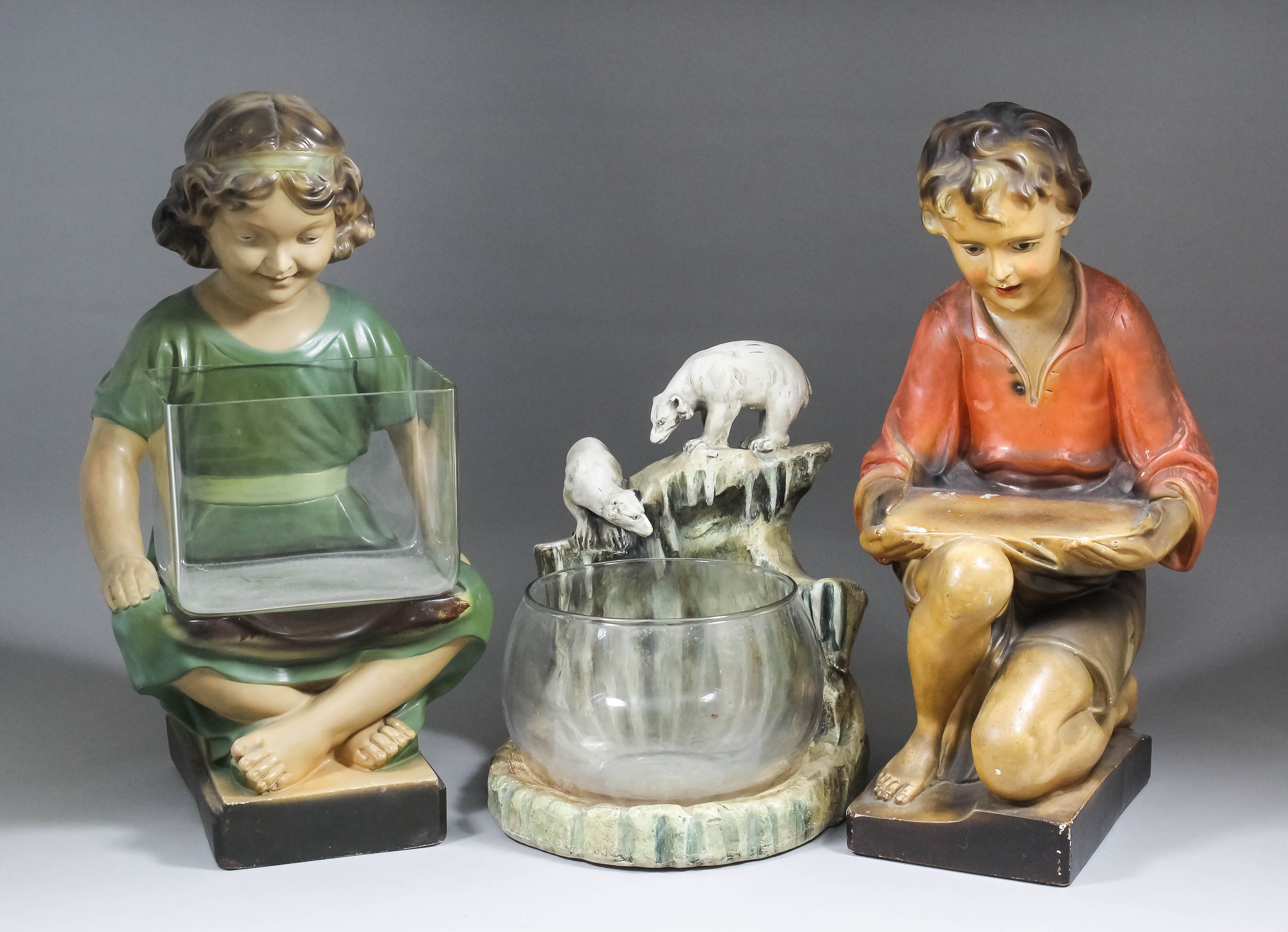 A 1920 's plaster goldfish bowl with stand modelled with two polar bears on an ice floe, 14ins high,