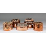 Five Victorian copper jelly moulds, comprising - circular example of triple tiered form, the plain