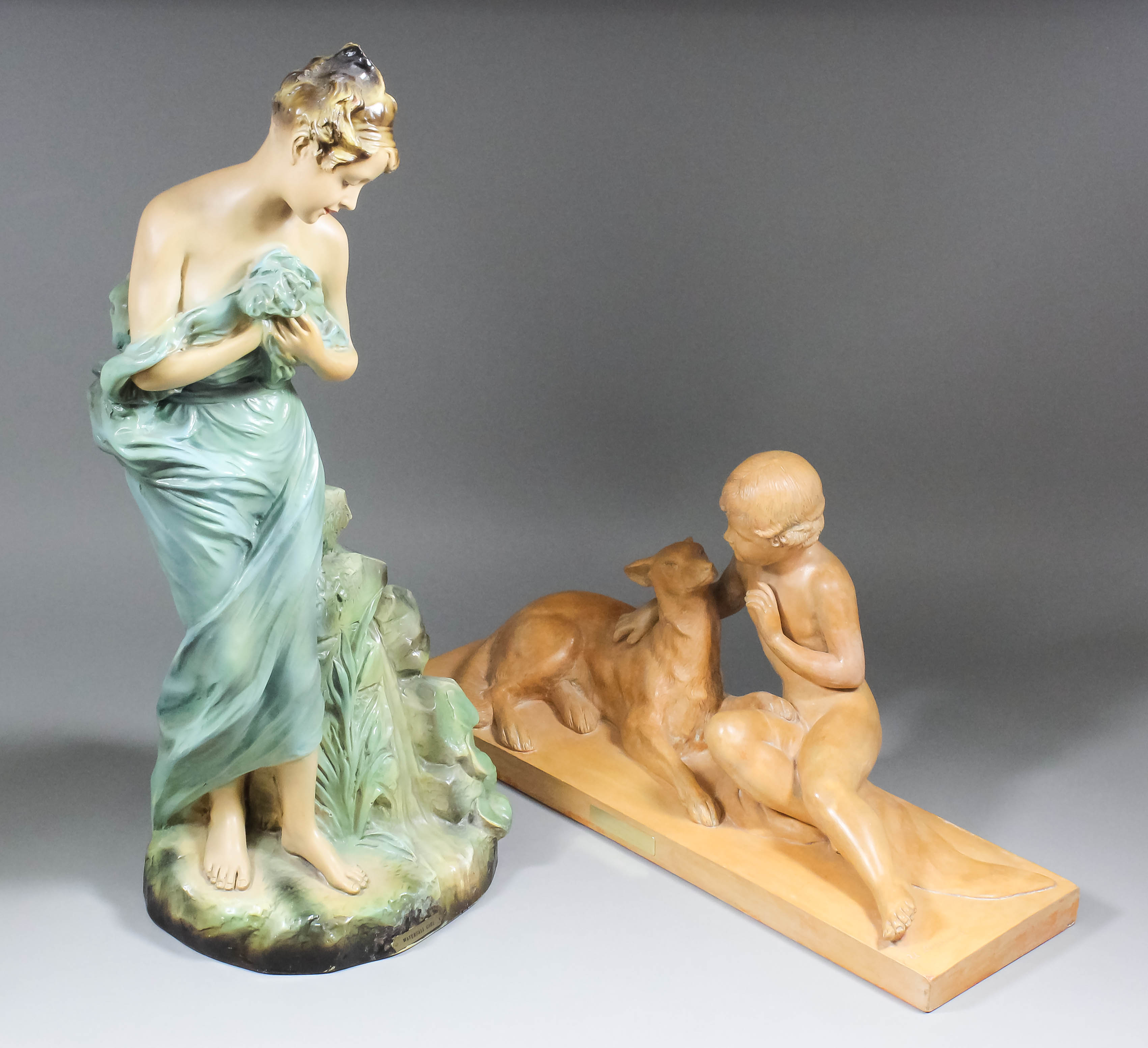 A 1920's painted terracotta group after Ugo Cipriani (1887-1960) of a seated boy with a dog, 25ins