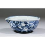 A Chinese blue and white porcelain circular pouring dish painted with a dragon and phoenix amongst