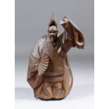 A Japanese carved wood okimono of an actor wearing an Okina mask carved in the "Ittobori" style, 9.