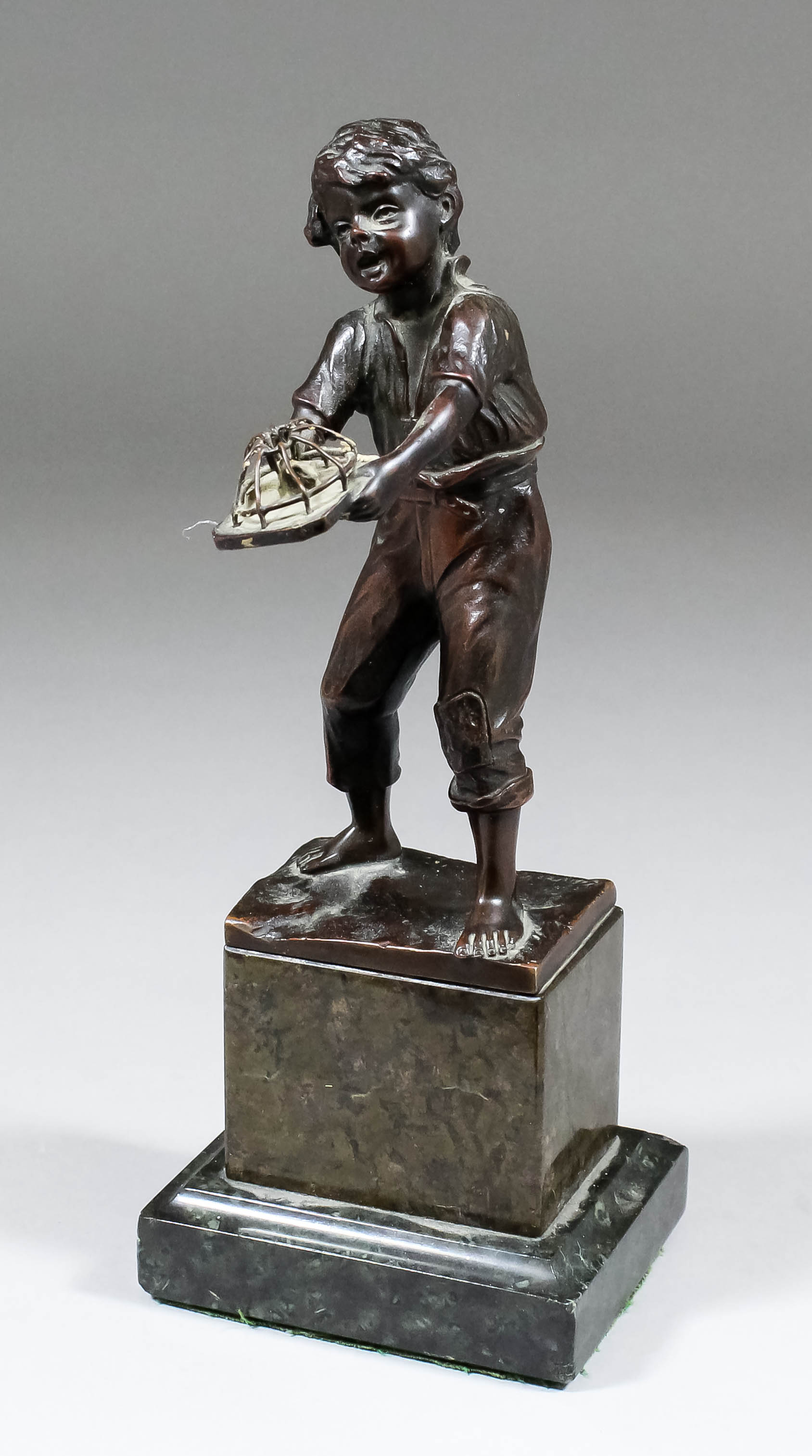 Late 19th/early 20th Century Eastern European School - Bronze figure of a standing urchin holding