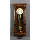 A late 19th Century walnut cased "Vienna Regulator" wall clock, the 7ins diameter cream enamel