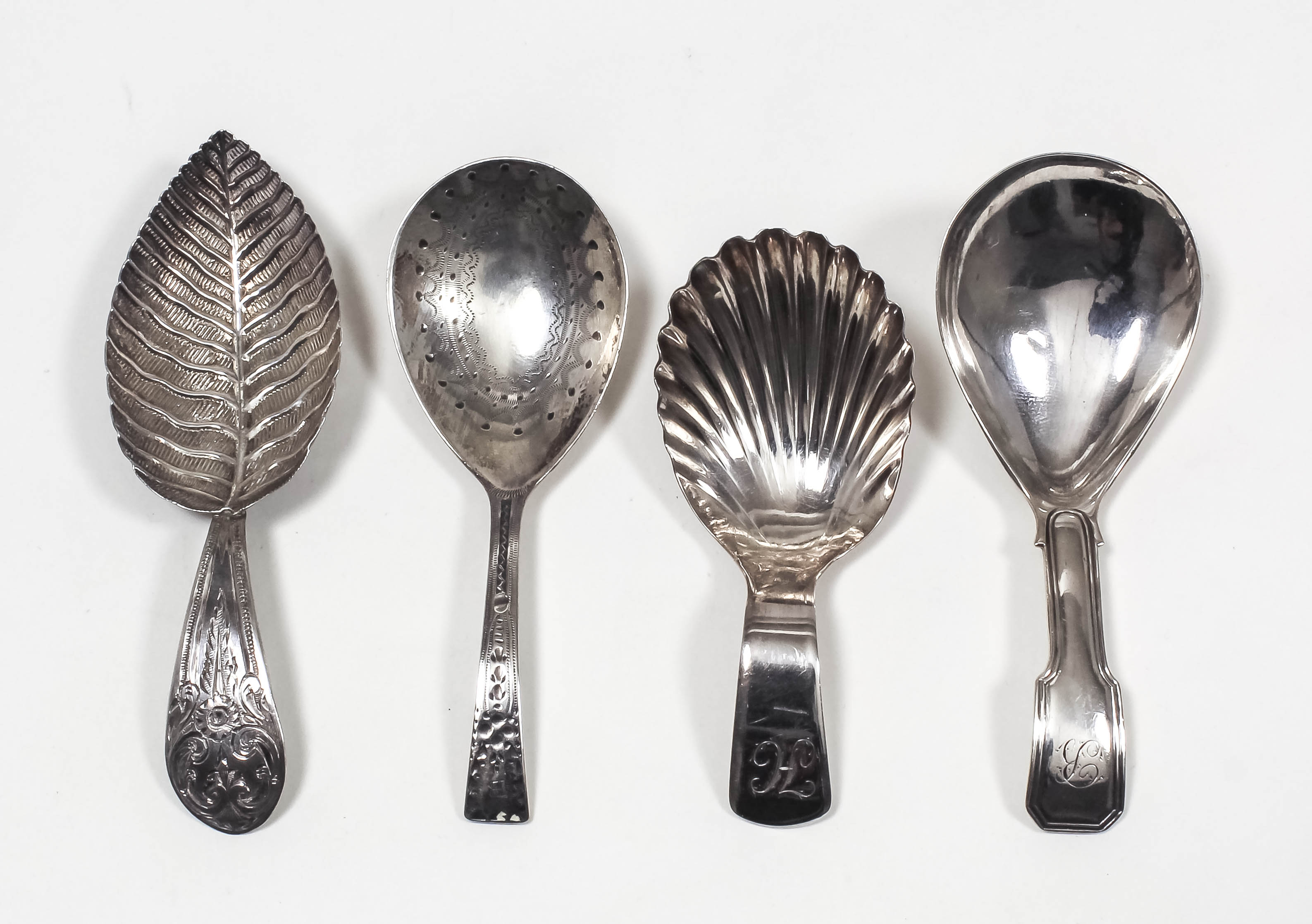 Three George III silver caddy spoons - with moulded leaf pattern bowl and engraved handle, by Joseph