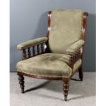 A Victorian walnut framed scroll back open arm easy chair with turned spindles to arms, the seat,