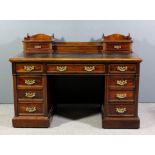 A late Victorian mahogany kneehole desk, the superstructure with lifting centre compartment