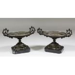 A pair of French bronze oval two-handled tazzas in the "Mannerist" style, on polished slate bases,