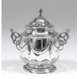 A late Victorian silver circular two-handled bowl and cover of Neo-classical design, embossed with