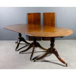A mahogany D-end three pedestal extending dining table of Georgian design with two extra leaves,