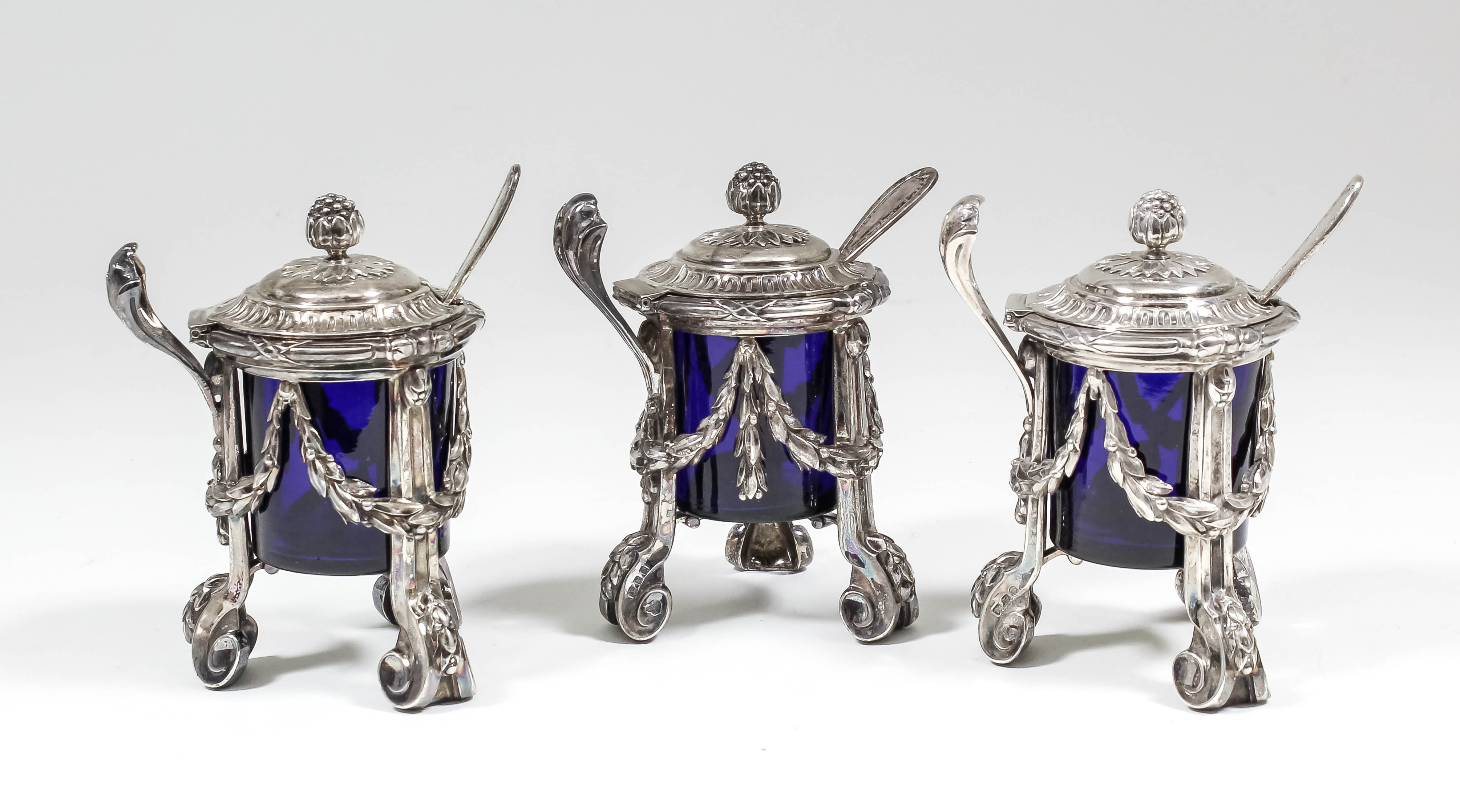 A pair of George V silver mustard pots of matching Louis XVI design, the lifting lids with pineapple