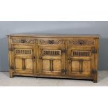 A panelled oak dresser base of "17th Century" design with moulded edge to top, fitted three frieze