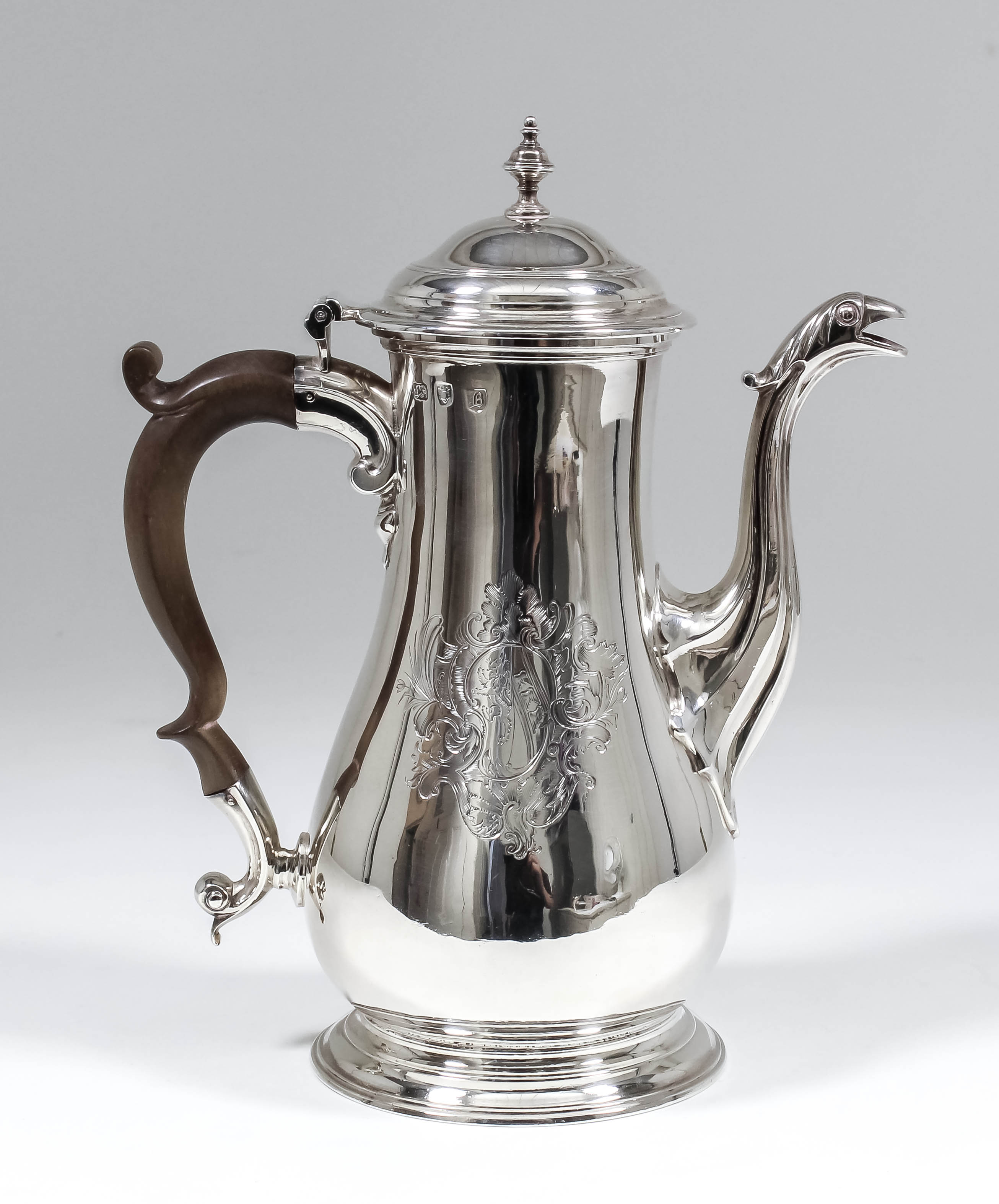 A George III plain silver baluster shaped coffee pot, the moulded and domed cover with turned finial