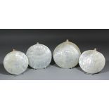Four late 19th/early 20th Century mother of pearl shell plaques, each variously carved with a