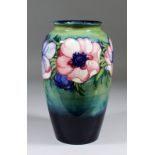 A Moorcroft pottery ovoid shaped vase tube lined and decorated in colours with "Anemone" design on a