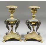 A pair of late 19th Century cast gilt brass and bronze candlesticks in the "Empire" manner, the