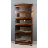 A Globe Wernicke stained wood five tier sectional bookcase, each tier enclosed by a rising glazed