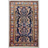 An antique Malayer rug woven in colours with a central pole medallion filled with four baskets of