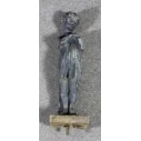 A cast lead standing figure of a young child clutching a bird to its chest, on square base, 30ins