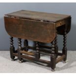 A 17th Century oak gateleg table with D-shaped flaps, fitted one frieze drawer, on bobbin turned