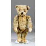 A 1910 small Steiff blond mohair teddy bear with black button eyes and hump, 11.5ins high