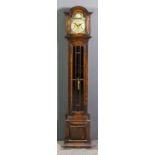 A 1920s oak "Grandmother" clock, the 11.5ins arched brass dial with silvered chapter ring with Roman