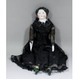 A 19th Century Continental porcelain headed doll, with black painted hair, composition body with