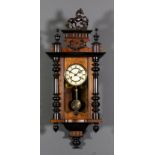 A late 19th Century walnut and ebonised "Vienna Regulator" wall clock, the 5ins diameter cream