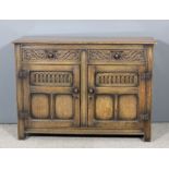 A panelled oak dresser base of "17th Century" design with moulded edge to top, fitted two frieze