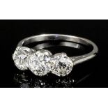 A silvery coloured metal mounted three stone diamond ring, the diamonds each approximately .50ct (
