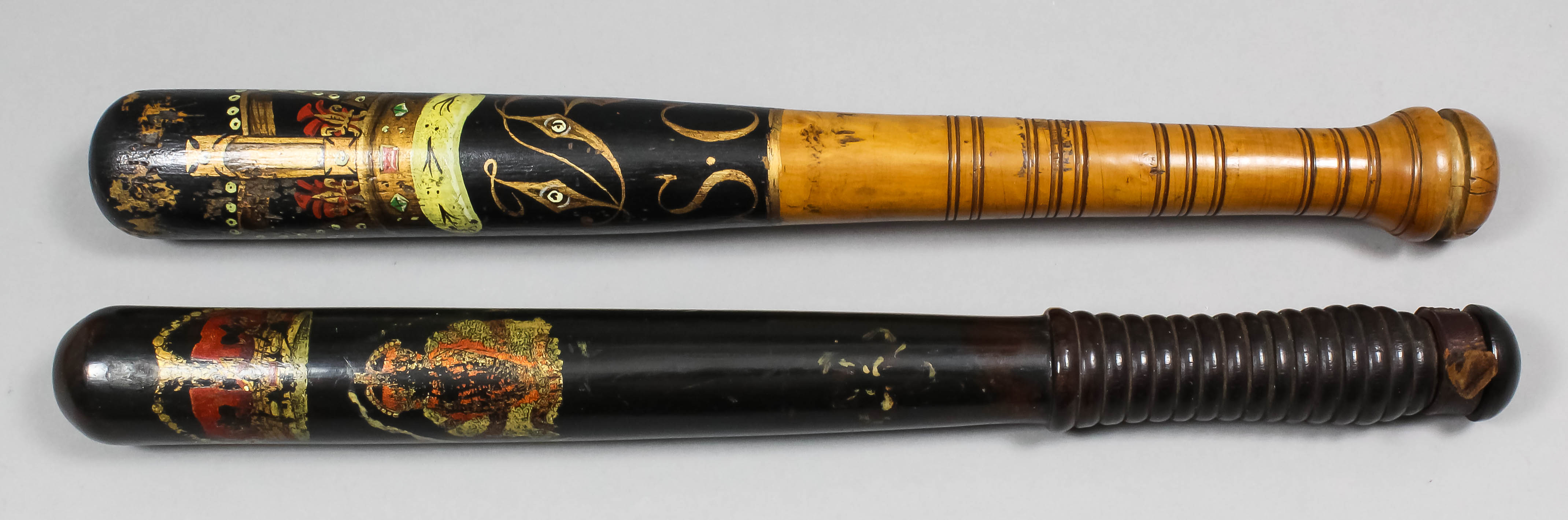 A Victorian turned wood truncheon painted with a crown over the royal cipher above "S.C." and "