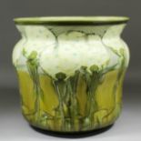 A large late 19th Century Minton glazed pottery jardiniere, the sides moulded with dandelion clocks,