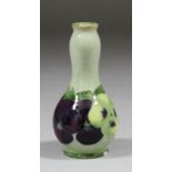 A Moorcroft miniature pottery vase decorated with "Pansy" pattern, 3.25ins high ("WM" in green and