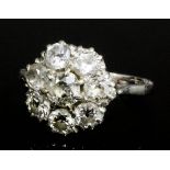 An Edwardian silvery coloured metal mounted all diamond set cluster ring, the central old cut