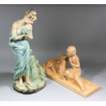 A 1920's painted terracotta group after Ugo Cipriani (1887-1960) of a seated boy with a dog, 25ins