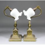 A pair of adjustable brass desk lamps on stepped bases, 16.5ins high, with later opaque glass shades