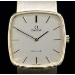 A 1980's gentleman's 14k gold Omega Deville wristwatch, the cushion shaped champagne dial with baton