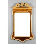 A mid 18th Century walnut and gilt rectangular wall mirror, the moulded scroll pediment with