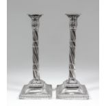 A pair of George III silver pillar candlesticks with cast leaf capitols, spiral reeded and fluted