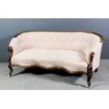 A Victorian mahogany framed low two seat settee with moulded showwood framing, upholstered in rose