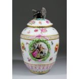 A late 19th Century Berlin porcelain vase and cover of baluster shape, the cover with eagle