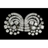 A 1920s silvery coloured metal mounted brooch or double dress clip at will, the scroll face set with