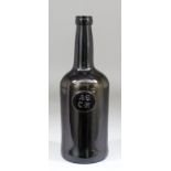 An early 19th Century dark green glass wine bottle with cylindrical body, bearing circular seal to