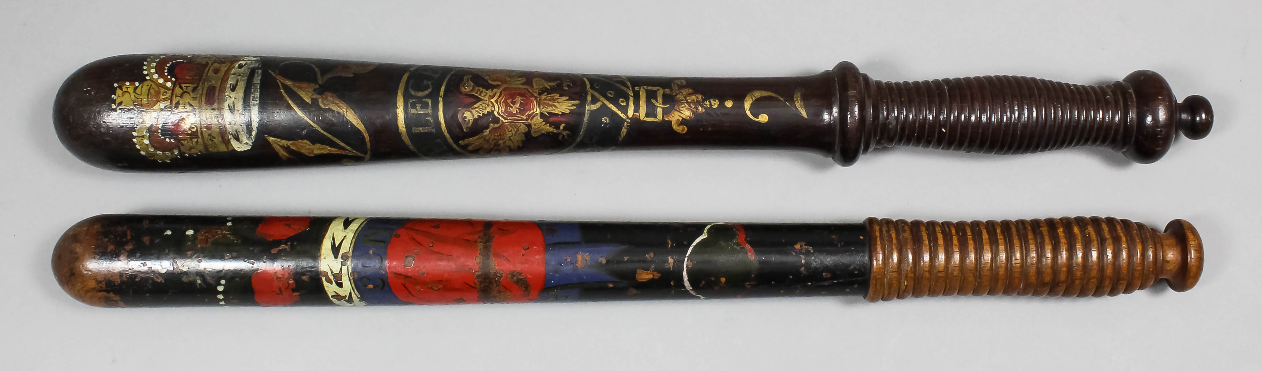 A Victorian turned wood truncheon painted with a crown over the royal cipher above the arms and