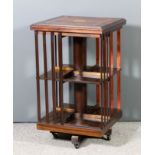 A mahogany square two tier revolving case in the Edwardian manner, the top with moulded edge and