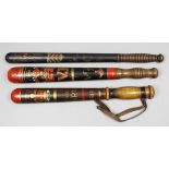 A Victorian turned wood truncheon painted with the royal crown over a "VR" cipher above the arms for