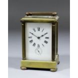 An early 20th Century French carriage timepiece with alarum, the white enamelled dial with Roman